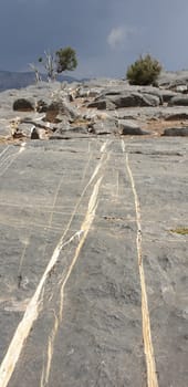 Calcite veins in the limestone rock on the plateau in front of the Grand Canyon of Jabal Shams in Oman.