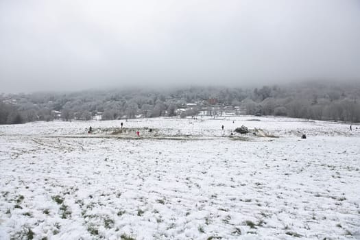Malvern, United Kingdom, 28th December, 2020: Peachfield road car park and football pitch area at the base of malvern hills. People enjoy fresh snow.