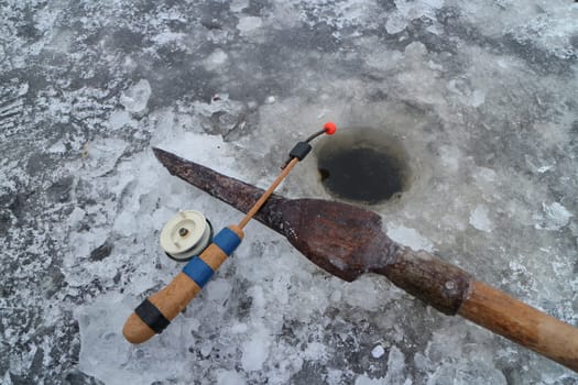 rod and gaff for winter fishing at the hole in the ice