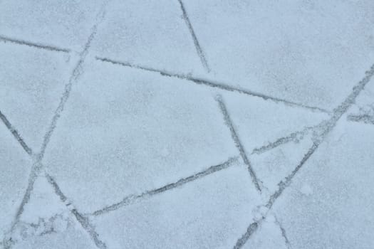 ice covered with snow lined skate tracks abstract white background