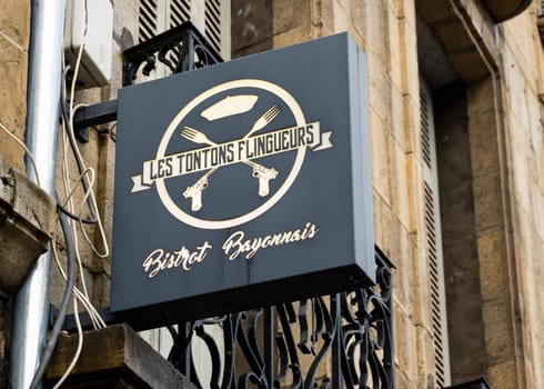 BAYONNE, FRANCE - CIRCA DECEMBER 2020: Les Tontons Flingueurs restaurant sign. The name comes from a movie from the same name.