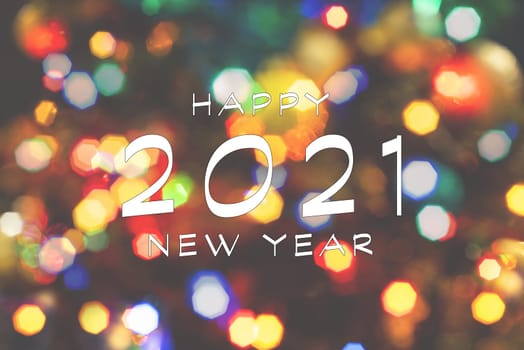 Happy New Year 2021 greeting card, blurred background of the twinkling lights of the Christmas tree. Greeting card background.