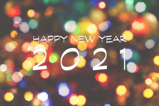 Happy New Year 2021 greeting card, blurred background of the twinkling lights of the Christmas tree. Greeting card background.
