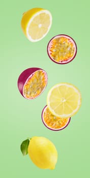Flying exotic fruits. Six pieces of falling lemon and maracuja isolated on green background with clipping path as package design element and advertising. Full depth of field.