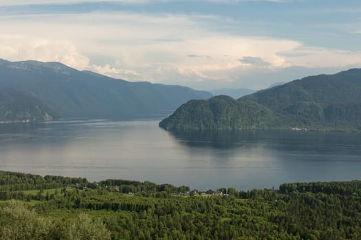 Lake Teletskoye with calm water on a summer day