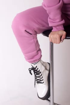 Female sneakers. White female shoes on feet.
