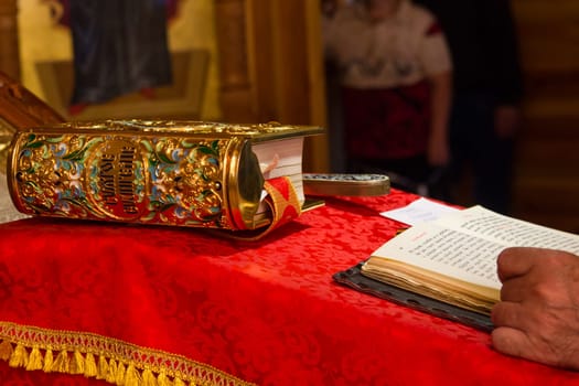 A priest holding the Bible at a christian ritual. Christian celebraton