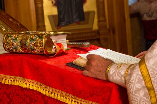 A priest holding the Bible at a christian ritual. Christian celebraton