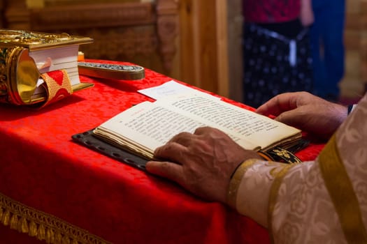 A priest holding the Bible at a christian ritual. Christian celebraton