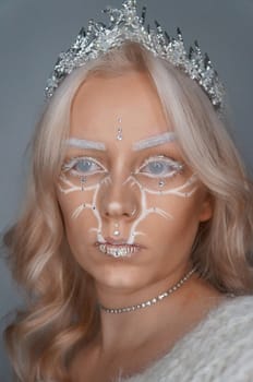 young blond woman with glitter makeup and crown