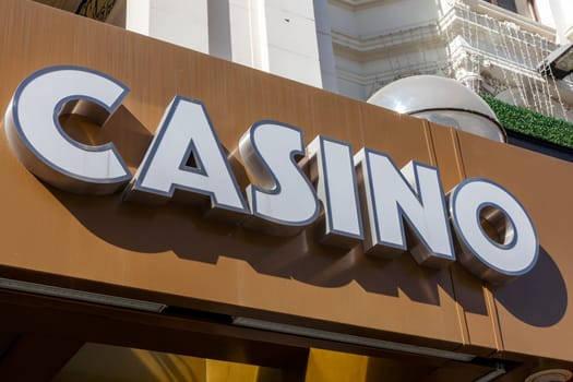 Casino sign outside a gambling venue tempting people to gamble at roulette poker and Black Jack, stock photo image