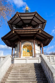 The Peace Pagoda in Battersea Park London England with gilded bronze gold Buddha statues which is a popular travel destination tourist attraction landmark of the city, stock photo image