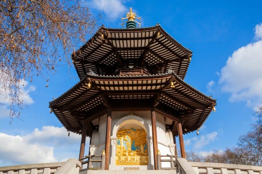 The Peace Pagoda in Battersea Park London England with gilded bronze gold Buddha statues which is a popular travel destination tourist attraction landmark of the city, stock photo image