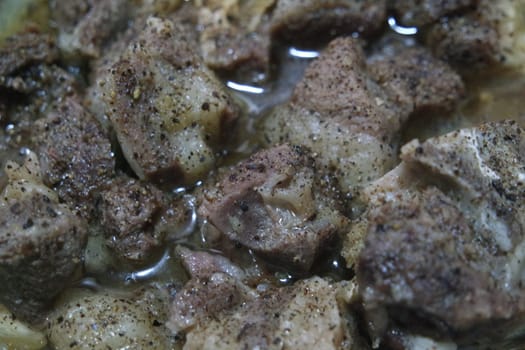 Top view of siri paaye or paya dish garnished with diced ginger, long coriander and black pepper. This dish is popular in Pakistan and Bangladesh