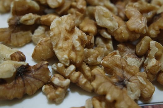 Close-up top view of peeled walnut on a white background. peeled walnut without shell ready to eat dry fruit.