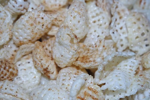 Closeup view of freshly fried chips as fast food for tea break. Potato chips with spices sprinkled on it. Fast food background for advertisements.