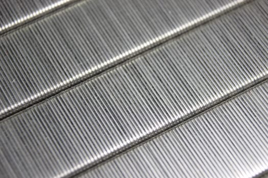 Metal staple pin close up macro background. Background for education and stationary items