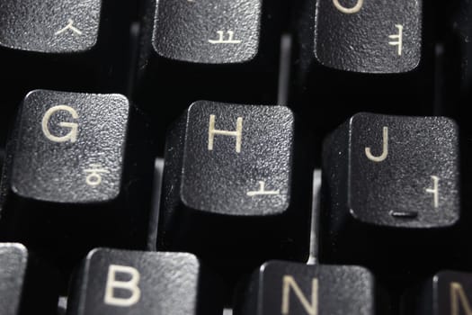 Closeup of laptop computer keyboard black keys with white letters and numbers. Black keys with white characters.