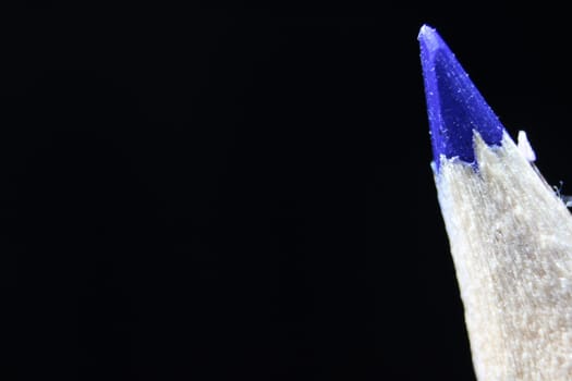 close up of sharpened pencil.Macro view of the tip of the pencil on a black background.