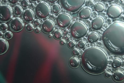 abstract macro background of oil circles floating over water surface . Macro closeup view of bubbles on water . oil bubbles in the water macro photographic background