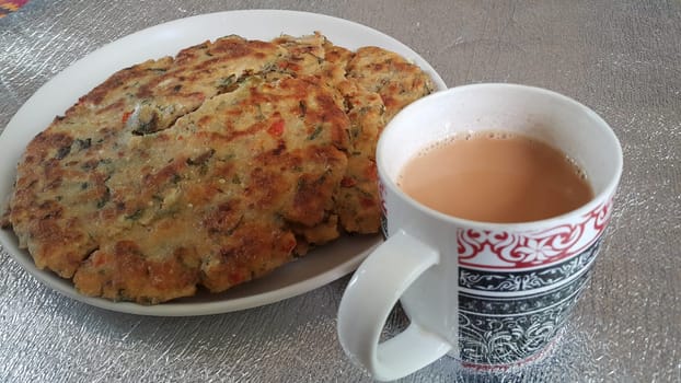 Closeup view of of traditional bread called Jawar roti or bhakri with tea cup. Bhakri is a round flat unleavened bread often used in the cuisine of many Asian countries