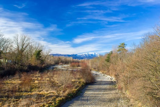 Dry river Schwarza in Bad Erlach and view of Rax Mountain in Lower Austria