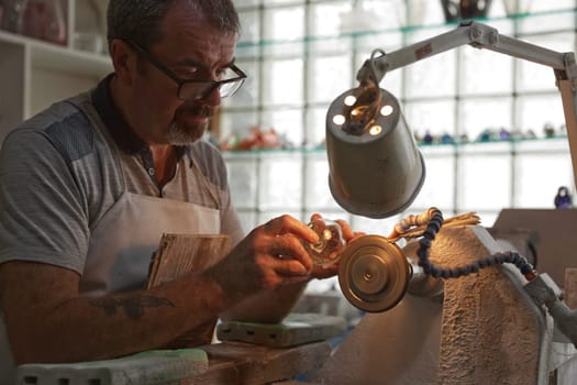 Waterford, Republic of Ireland - June 13, 2017: A craftsman working in the Sculpting Department at the Waterford Crystal factory, in the city of Waterford, Republic of Ireland.