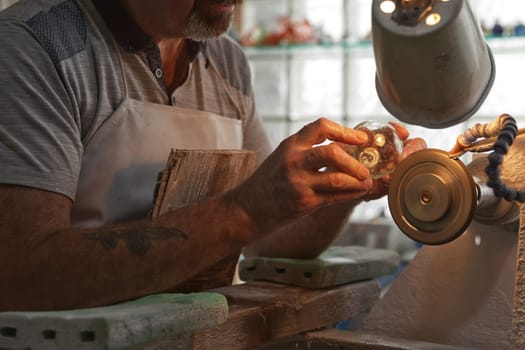 Waterford, Republic of Ireland - June 13, 2017: A craftsman working in the Sculpting Department at the Waterford Crystal factory, in the city of Waterford, Republic of Ireland.