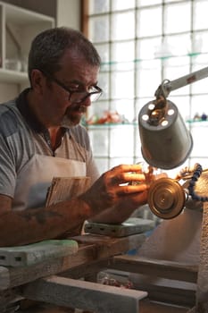 Waterford, Republic of Ireland - June 13, 2017: A craftsman working in the Sculpting Department at the Waterford Crystal factory, in the city of Waterford, Republic of Ireland.