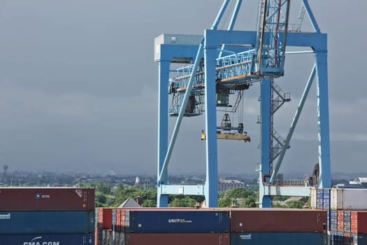 Dublin, Ireland - June 6, 2017: Large industrial cranes loading container ship in Dublin Port in Ireland.