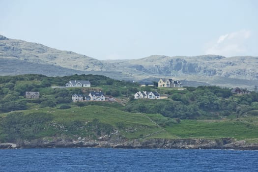 People enjoying living in beautiful landscape full of rock formations along the irish coastline near Killybegs, County Donegal in Ireland.