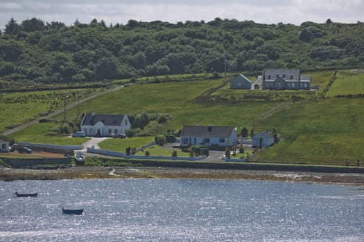 People enjoying living in beautiful landscape full of rock formations along the irish coastline near Killybegs, County Donegal in Ireland.