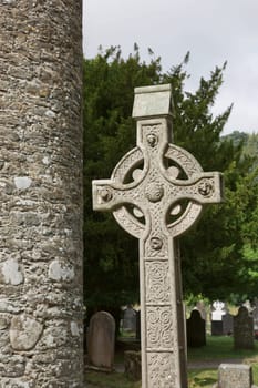 Stone round tower and some ruins of a monastic settlement originally built in the 6th century in Glendalough valley, County Wicklow, Ireland.