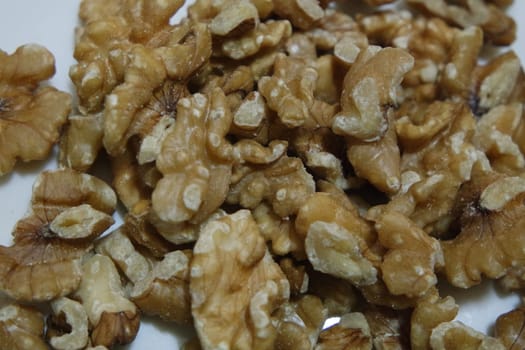 Close-up top view of peeled walnut on a white background. peeled walnut without shell ready to eat dry fruit.