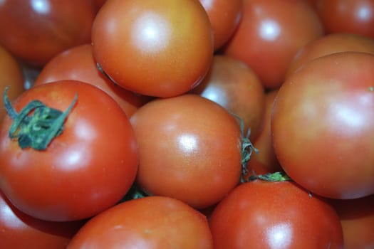 Close-up view of red tomatoes in market for sale. A fruit background for text and advertisements