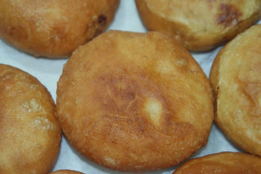 Closeup view of homemade tasty potato bread rolls bun placed over white tissue paper.