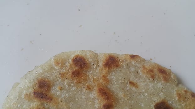 Closeup view of of traditional bread called Jawar roti or bhakri on white background. Bhakri is a round flat unleavened bread often used in the cuisine of many Asian countries