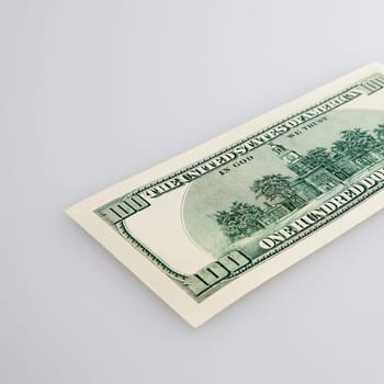 One hundred dollar cash bill on a light background. Layout, mockup, place for lettering and logo.