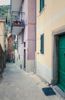 View down a narrow residential street in the village of Manarola in Cinque Terre National Park, Italy