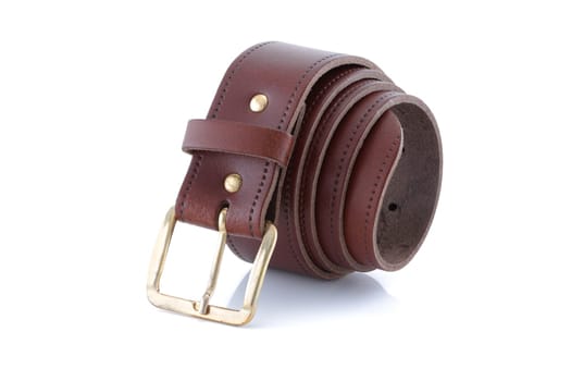 A leather belt brown with gold buckle rolled up on a white background with shadow