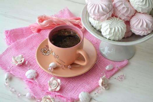 Russian marshmallow or zefir dessert on white plate with coffee cup on shabby wooden background