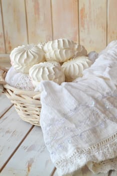 Russian dessert zefir. Tender marshmallows on shabby wooden background. Rustic Valentines zefir on white lace and wooden table
