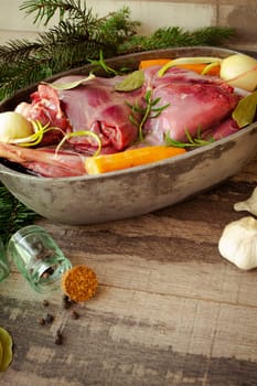 Venison goulash stew in pot with hare and rabbit, vertical image