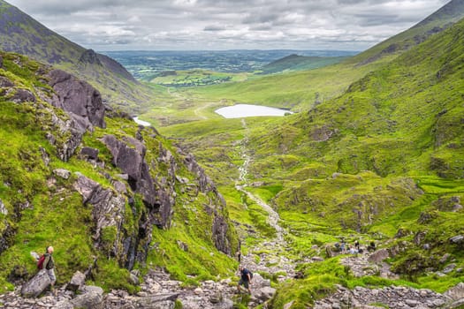 Killarney, Ireland, July 2019 Group of hikers climbing Devils Ladder, difficult trail, to reach highest Irish mountain Carrauntoohil, Ring of Kerry