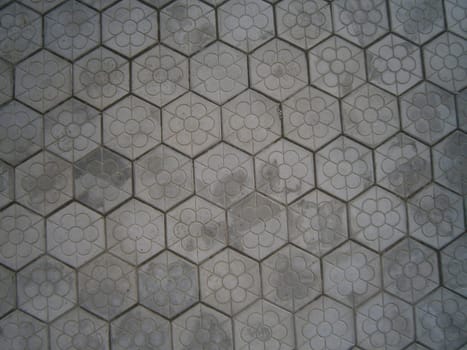 The background is the texture of the tile. The pattern and texture of the tile is construction.