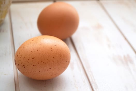 Brown chicken eggs close up on white background, space for text