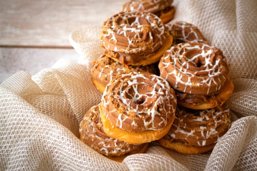 A lot of chocolate cookies with boiled condensed milk in the confectionery industry. Close up