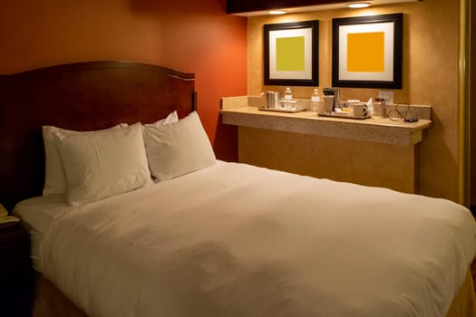 View of a comfortable hotel room with warm and relaxing colors.