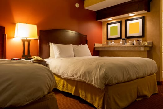 View of a comfortable hotel room with warm and relaxing colors.