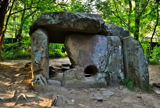 Ancient old dolmen in the forest. Antique buildings.